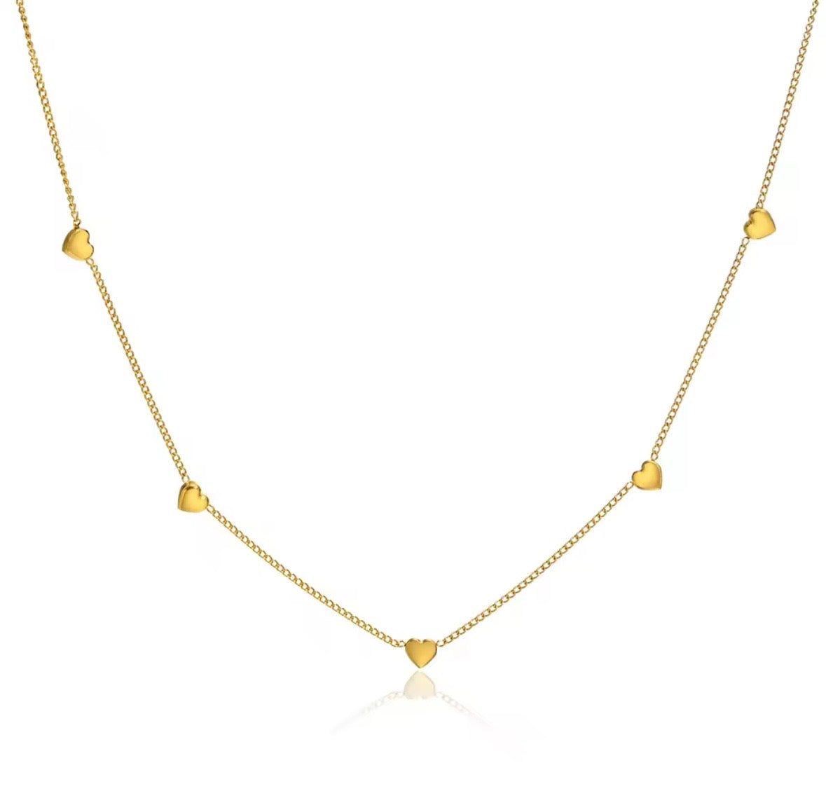 A delicate gold chain necklace featuring five small, evenly spaced heart charms, displayed against a clean white background with a subtle reflection below. 
