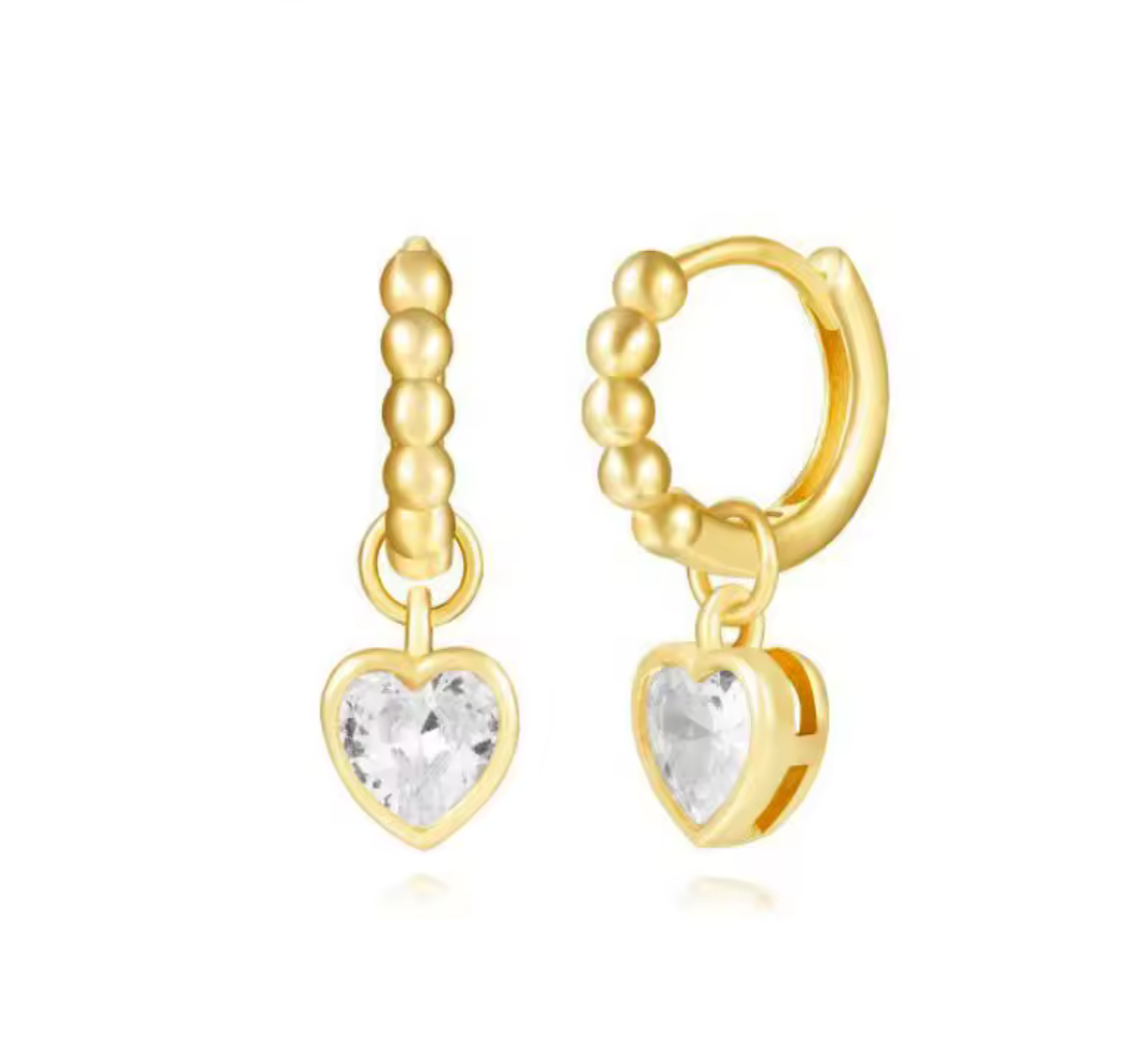 Gold bobble hoop earrings with heart-shaped gemstones on a white background
