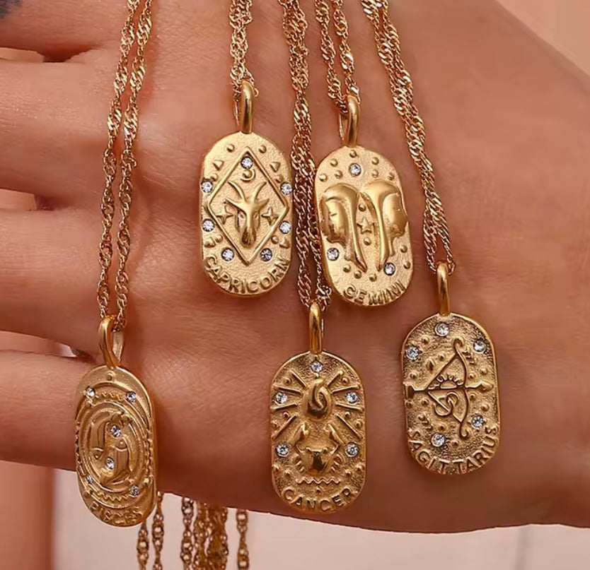 
                  
                    A dainty gold zodiac necklace inspired by vintage tarot cards — finished with sparkling CZ details and a twisted rope chain. 
                  
                