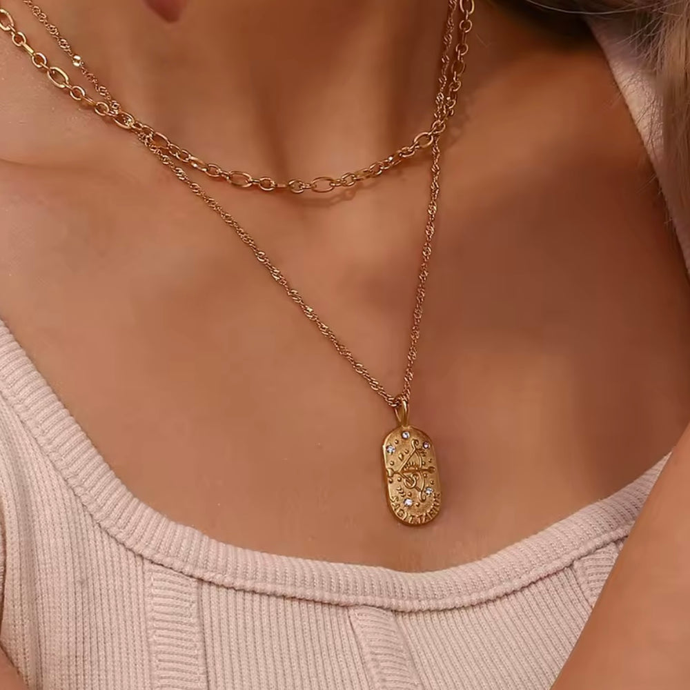 
                  
                    A dainty gold zodiac necklace inspired by vintage tarot cards — finished with sparkling CZ details and a twisted rope chain. 
                  
                