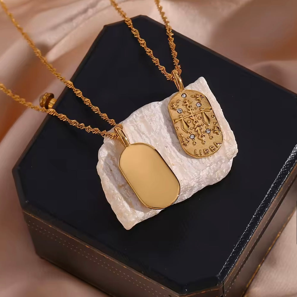 
                  
                    A dainty gold zodiac necklace inspired by vintage tarot cards — finished with sparkling CZ details and a twisted rope chain. 
                  
                