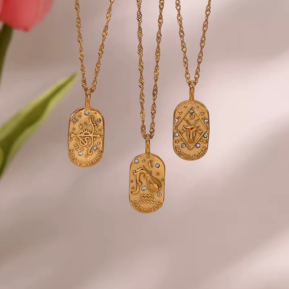 
                  
                    A dainty gold zodiac necklace inspired by vintage tarot cards — finished with sparkling CZ details and a twisted rope chain. 
                  
                