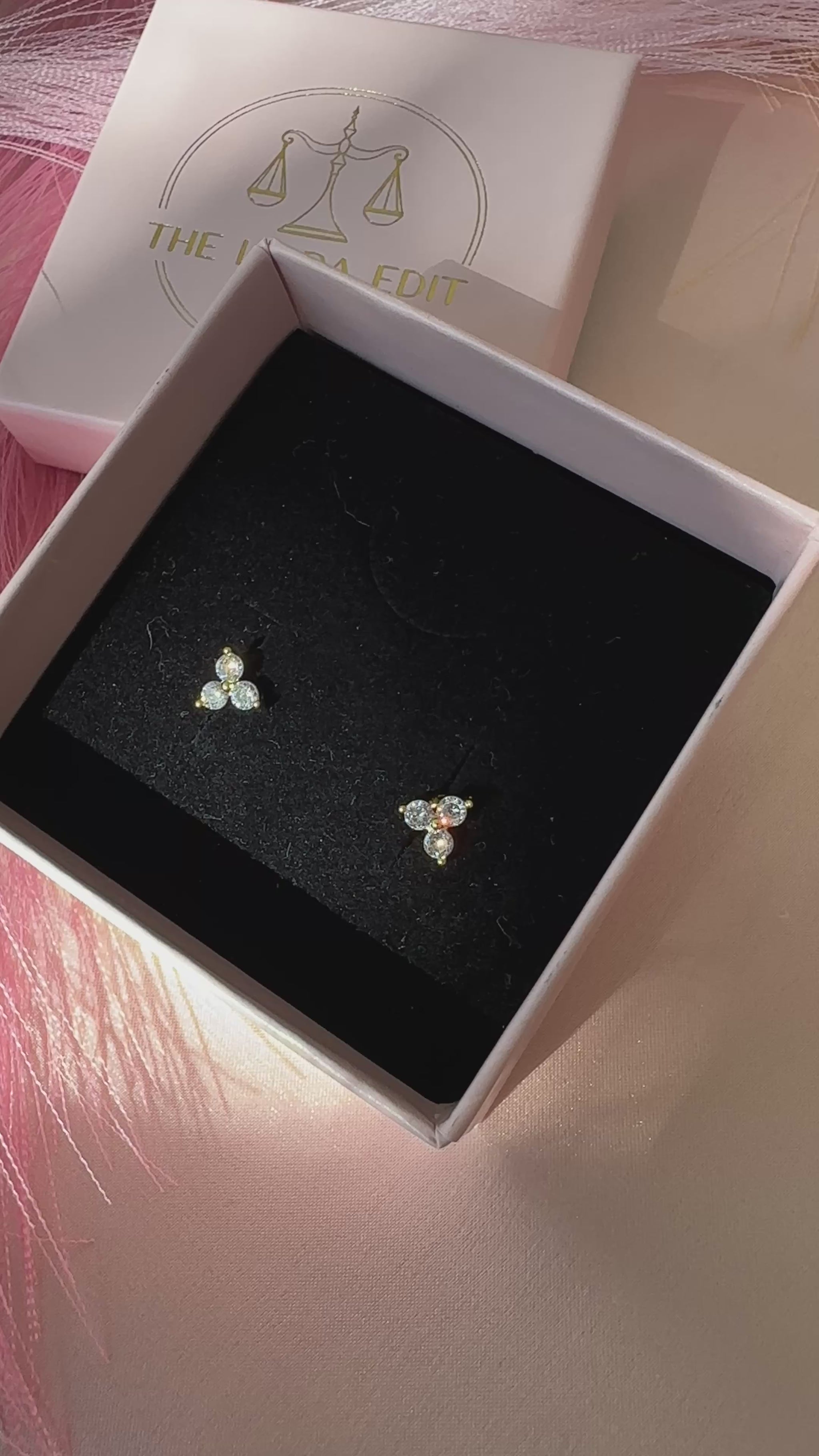 triple crystal stud earrings shining in sunlight in a black velvet gift box