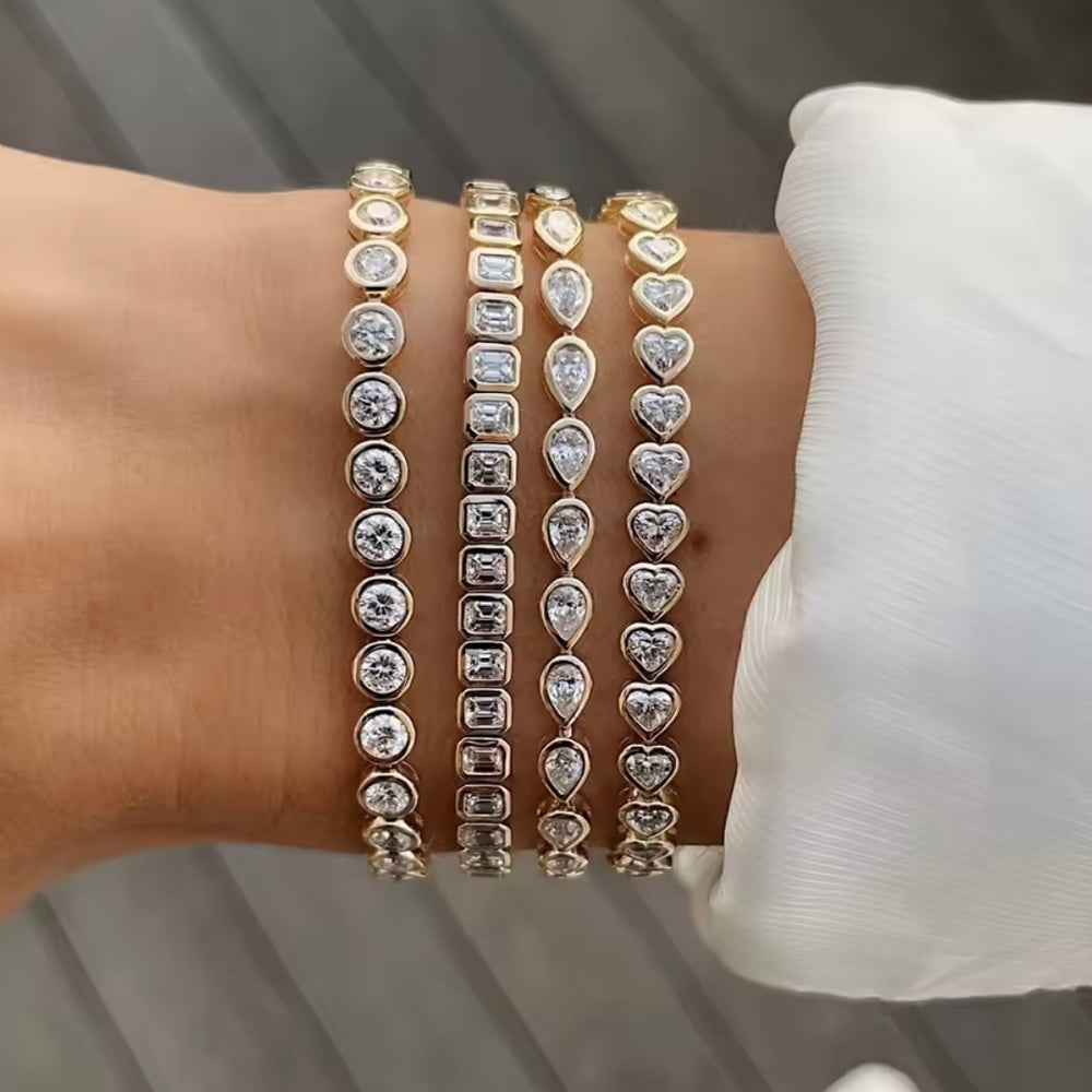 
                  
                    Silver  tennis bracelet with clear CZ bezel set stones on a wrist
                  
                